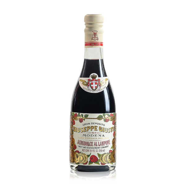 Flasche Giusti Agrodolce al Lampone Balsamico, elegant vor hellem Hintergrund präsentiert – eine fruchtige Essigspezialität mit Himbeeren, perfekt für kreative Salate und Desserts.